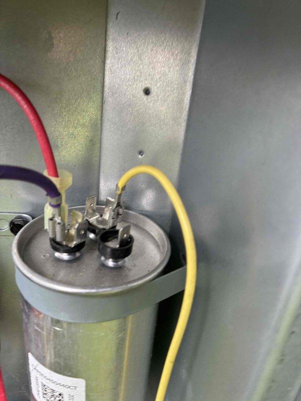 Completed cooling system tune-up on residential HVAC unit. Inspected and tested dual run capacitor and electrical connections, verified proper voltage at terminals, and examined control board components for proper operation. All systems found operating within normal parameters with no deficiencies noted.