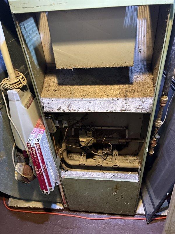 Completed HVAC estimate for forced air furnace replacement with add-on options. Inspection revealed aging furnace unit with significant dust accumulation, worn internal components, and extensive frost buildup on evaporator coil and refrigerant lines indicating potential refrigerant leak or airflow restriction. Documented existing system condition including deteriorated insulation, corroded heat exchanger, and moisture-related issues throughout mechanical compartment requiring full system replacement.