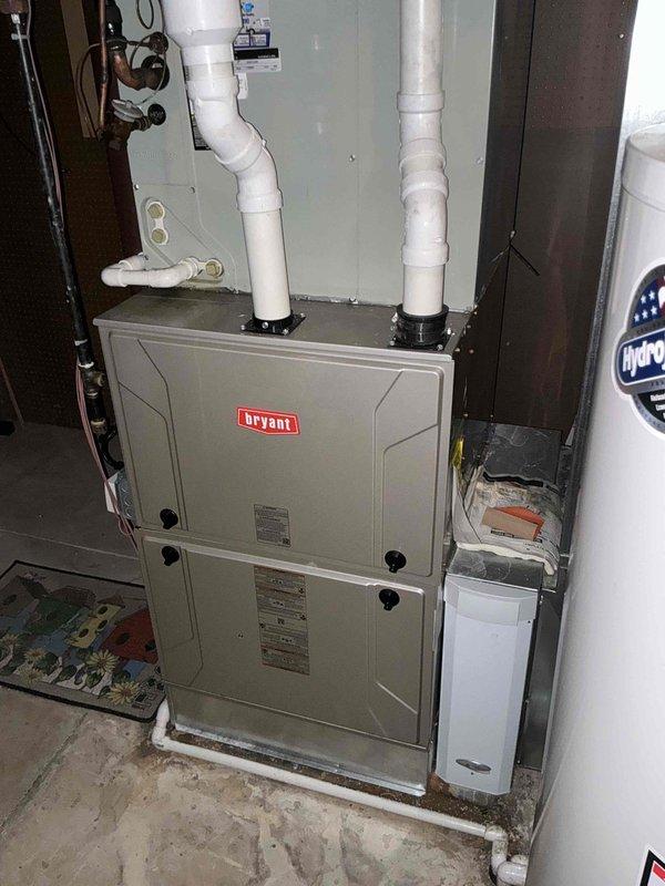 Responded to no cooling complaint and evaluated existing Bryant HVAC system. Assessed equipment condition and provided customer with replacement options for air conditioning system. Documented field measurements and equipment specifications including ductwork dimensions and system capacity requirements. Photographed current installation showing furnace, venting configuration, and associated plumbing and electrical connections for replacement planning purposes.