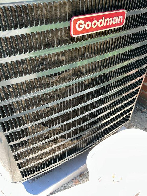 Responded to service call for non-operational Goodman AC unit with reported loud startup noise. Performed comprehensive maintenance inspection on 9-year-old system. Found significant debris accumulation and dirt buildup on condenser coil fins, with heavy contamination on one side restricting airflow and reducing heat exchange efficiency. Cleaned condenser coils thoroughly to restore proper airflow and system performance. Inspected electrical connections and refrigerant lines. Addressed loud startup noise concern through system evaluation. Unit restored to operational condition with improved cooling efficiency following coil cleaning and maintenance procedures.