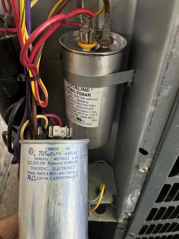 Replaced failed dual-run capacitor with new TOTALINE P291-7054R unit rated at 70/5μF, 440VAC. Installed surge protection devices on both indoor air handler and outdoor condensing unit to protect control boards and compressor from voltage spikes and power surges.