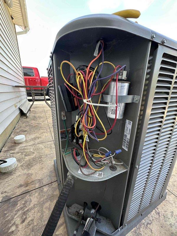 Completed preventive maintenance on 5-year-old Lennox cooling system. Inspected outdoor condensing unit electrical components including dual capacitors, control wiring harness, and terminal connections. All electrical connections found secure with normal operational wear; terminal block showing age-appropriate oxidation but functioning within specifications. Verified proper wire routing and strain relief. Unit operating efficiently with no immediate service concerns identified.