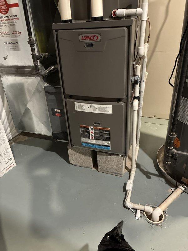 Conducted comprehensive assessment of existing Lennox furnace system to evaluate heating capacity concerns. Documented current equipment configuration including furnace unit, associated PVC venting, copper refrigerant lines, and system components to develop full replacement options addressing potential undersizing issues for the residence.
