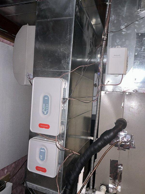Responded to service call for non-functioning air conditioning system in recently purchased home where existing HVAC configuration was uncertain. Upon inspection, identified an unconventional geothermal or hybrid system setup with multiple control zones and aging ductwork infrastructure. Documented electrical panel configuration and existing HVAC equipment installation, including air handler unit, multi-zone control panels with digital displays, and insulated refrigerant lines. Assessed overall system condition, noting accumulated dust on ductwork and wear on mechanical components. Provided comprehensive estimate for complete HVAC system replacement to address operational issues and clarify system type for new homeowners.