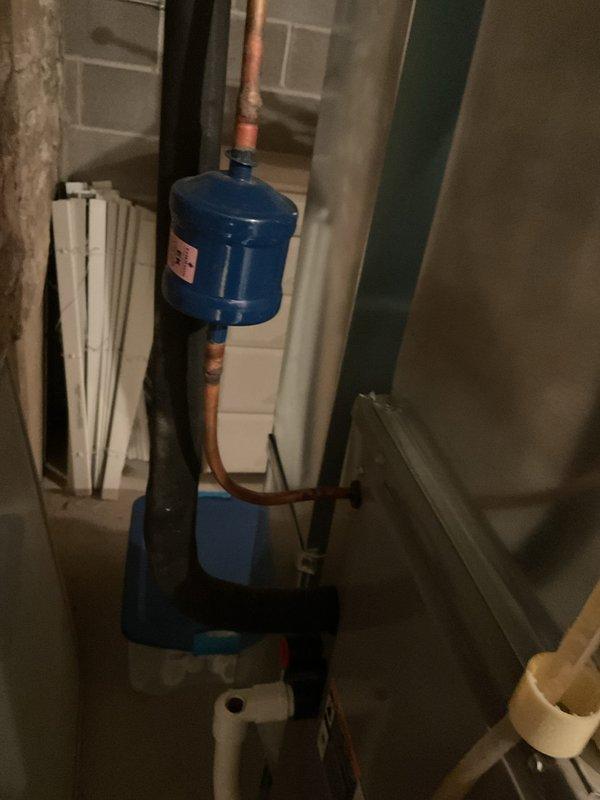 Completed scheduled preventive maintenance on residential cooling system. Inspected HVAC equipment, ductwork, and associated mechanical components in basement utility area. Verified proper operation of condensate pump assembly and drainage system, checked water treatment filter on copper supply lines, and documented equipment conditions with photographic records for service history.