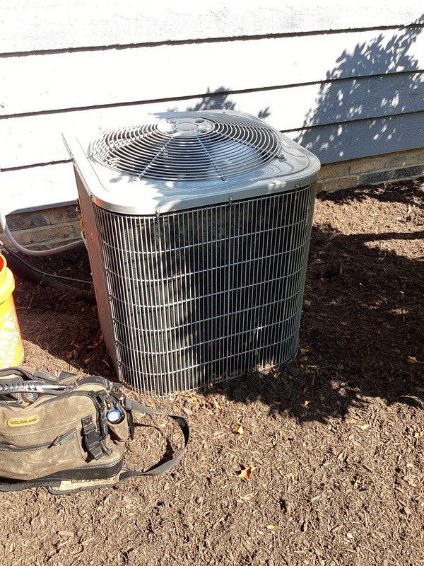 # HVAC Maintenance Summary

Completed scheduled preventive maintenance on two residential cooling systems as part of ongoing service plan. Performed comprehensive inspection of outdoor condenser units, including examination of compressor operation, refrigerant levels, and electrical connections. Verified proper capacitor function and assessed control wiring configurations. All systems operating within normal parameters upon completion of maintenance visit.

# Detailed Work Performed

Conducted routine cooling season maintenance on dual HVAC systems. Inspected exterior condenser units positioned at ground level, evaluating overall equipment condition and operational status. Examined cylindrical condenser with vertical fin configuration, confirming adequate airflow through coil surfaces and proper fan motor operation.

Accessed electrical control compartments to inspect internal components and wiring connections. Evaluated black circular capacitor mounted to control panel, verifying secu