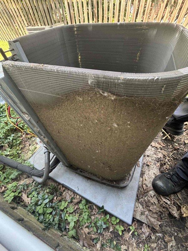 Performed comprehensive cleaning service on outdoor condensing unit that showed significant dirt and debris accumulation at base and throughout system. Removed and thoroughly cleaned blower wheel, performed detailed coil cleaning to restore heat transfer efficiency, and serviced feed tube. Unit exhibited heavy environmental contamination including sediment buildup, indicating extended exposure to outdoor elements. All components cleaned and restored to proper operating condition.