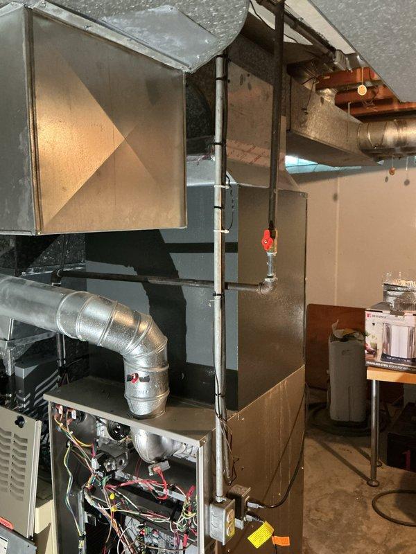 Responded to service call regarding condensation issues identified by city inspector around evaporator coil and ductwork perimeter. Performed thorough inspection of HVAC system installation, documenting existing conditions of heating unit, metallic ductwork connections, refrigerant lines, and insulated duct board assembly. Assessed moisture accumulation patterns around coil cabinet and adjoining ductwork to determine source and extent of condensation concerns for code compliance verification.
