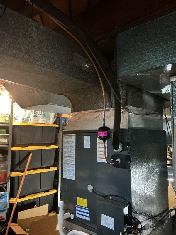 Responded to service call regarding condensation issues identified by city inspector around evaporator coil and ductwork perimeter. Performed thorough inspection of HVAC system installation, documenting existing conditions of heating unit, metallic ductwork connections, refrigerant lines, and insulated duct board assembly. Assessed moisture accumulation patterns around coil cabinet and adjoining ductwork to determine source and extent of condensation concerns for code compliance verification.