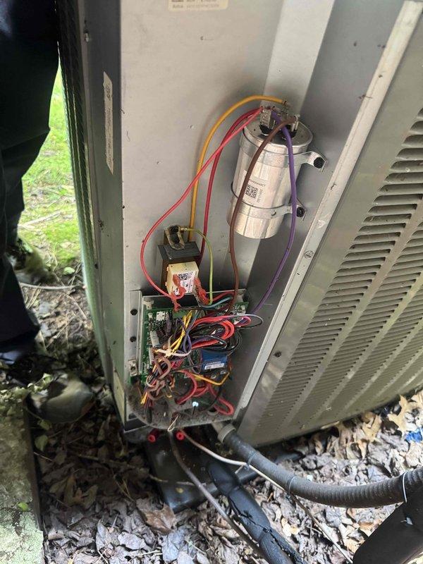 Responded to no cooling complaint following recent rain storm. Upon inspection, found outdoor unit had experienced electrical component failure due to water intrusion. Accessed control panel and identified damaged capacitor and compromised control board with visible moisture damage. Captured diagnostic photos showing corroded connections and affected circuitry displaying error code 62. Replaced failed dual-run capacitor, cleaned and dried electrical connections, and tested contactor operation. Verified proper voltage readings and confirmed system returned to normal cooling operation with no further error codes displayed.