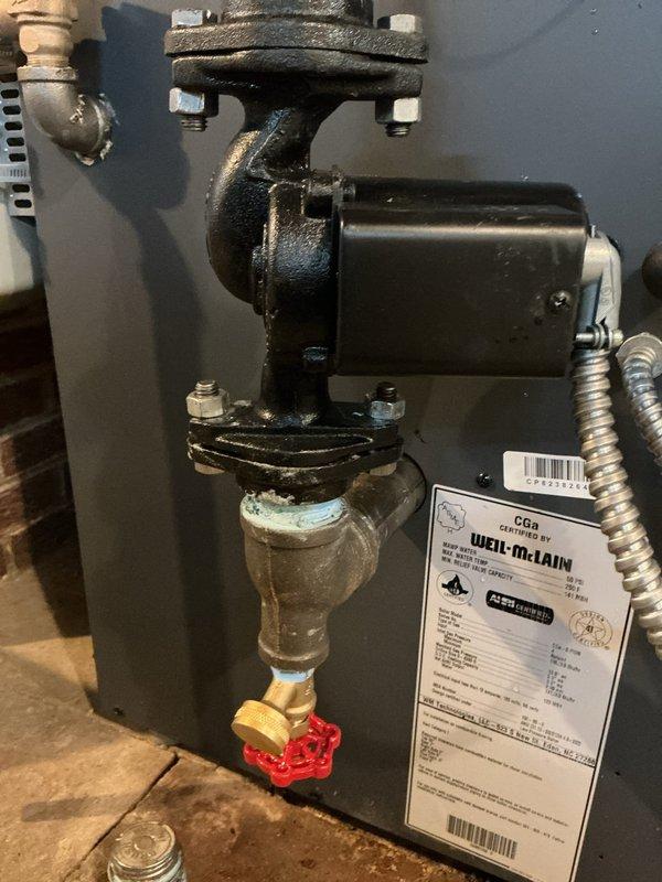 Installed new T-bell fittings (11/4-11/4 and 3/4) with threaded nipples and drain valve on water heater plumbing system. Replaced aging copper pipe connections and valve assembly showing corrosion and mineral deposits. All components tested and verified operational upon completion.