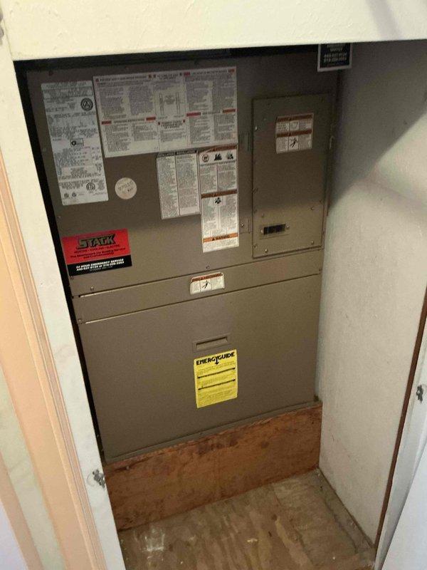 Conducted on-site evaluation for Magic Pak HVAC system replacement serving two rooms. Assessed existing unit installation in utility closet, documented electrical panel configuration with breaker assignments for furnace and AC circuits, and photographed current equipment specifications including energy ratings to provide replacement options.