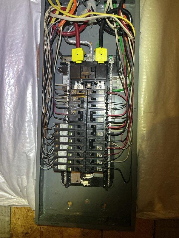 Completed comprehensive electrical panel inspection at residential property. Documented existing electrical panel configuration, including dual-row circuit breaker arrangement, wire routing from service entrance, and overall panel organization. Photographed panel interior showing proper wire management with color-coded conductors and terminal connections for maintenance records. Inspected surrounding utility area and storage space adjacent to electrical equipment to assess clearance requirements and accessibility compliance.