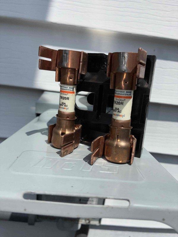Completed routine HVAC cooling maintenance on residential system. Inspected and photographed exterior service disconnect box and fuse assembly, confirming proper electrical connections, verifying fuse ratings at 250V, and ensuring all safety components were functioning correctly. All equipment operational with no issues identified.