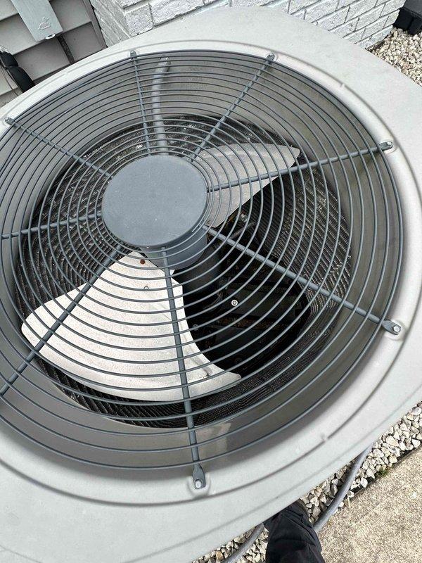 Performed thorough coil wash on outdoor condenser unit to restore optimal heat transfer efficiency. Cleaned condenser coils, fan assembly, and protective guard to remove accumulated debris and buildup. Unit operational with improved airflow following service completion.