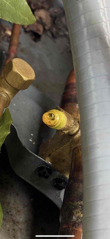 Responded to service call for AC system running continuously but failing to cool entire home on one-year-old installation. Upon inspection, discovered corroded copper refrigerant line with significant oxidation and a faulty Schrader valve core causing refrigerant leak. Removed and replaced defective valve core, which was preventing proper system pressure. Confirmed best contact information and rescheduled appointment for following morning to complete full system pressure test, refrigerant recharge, and verify proper cooling operation throughout home.