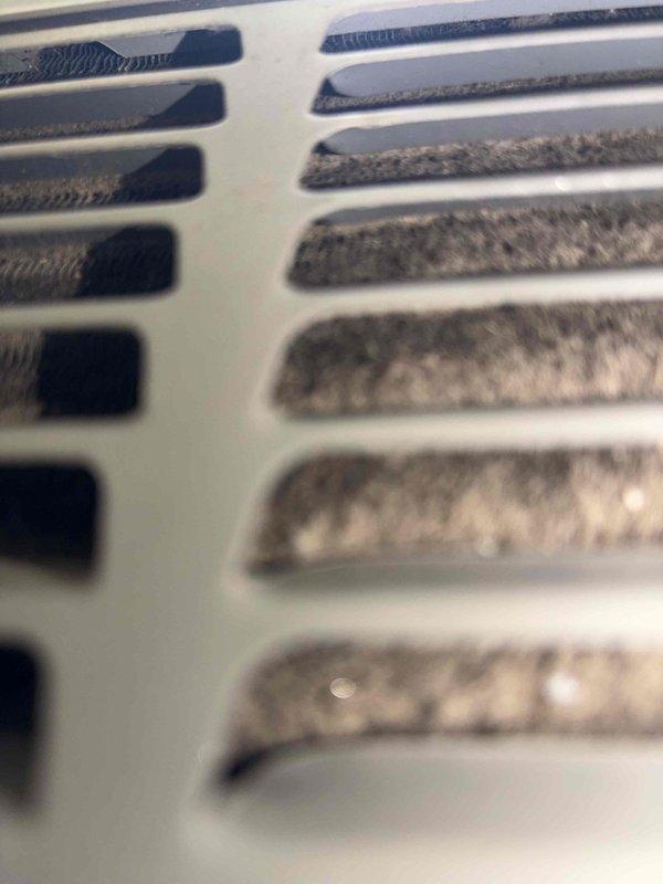 Completed cooling season tune-up service on residential HVAC system. Performed system diagnostics including temperature differential measurements on supply ductwork using calibrated digital thermometer, confirming proper airflow and cooling performance. Noted significant dust accumulation on return air grille requiring attention for optimal system efficiency and indoor air quality.