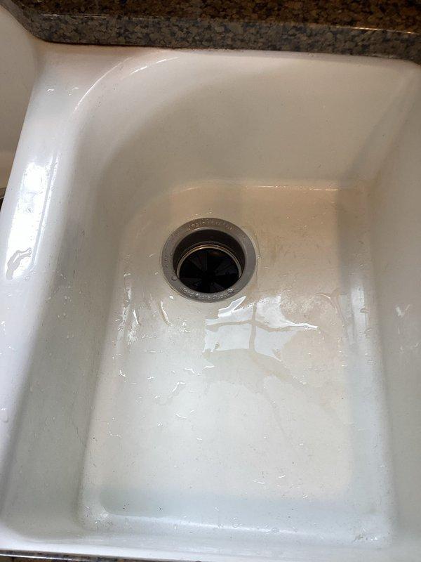Installed a new Badger 5 garbage disposal unit under the kitchen sink, including complete plumbing connections with PVC drain pipes, P-trap configuration, and electrical hookup. Verified proper operation and confirmed all connections were secure and leak-free.