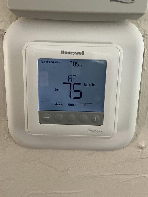 Responded to service call for two non-operational air conditioning systems with issues reportedly stemming from maintenance performed in late May. Upon arrival, inspected both Honeywell ProSeries programmable thermostats which were displaying proper settings in cooling mode with fan set to auto, with current temperatures reading 75°F and setpoints at 85°F. Documented thermostat conditions and system status for further diagnostics and troubleshooting of the cooling failure.