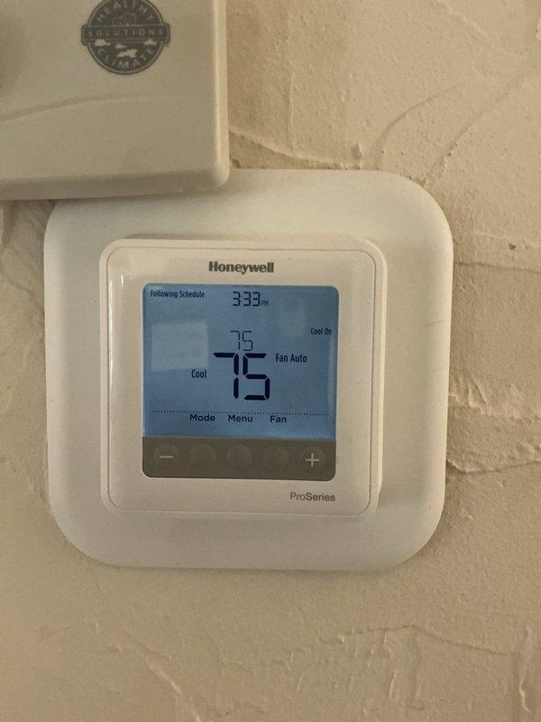Responded to service call for two non-operational air conditioning systems with issues reportedly stemming from maintenance performed in late May. Upon arrival, inspected both Honeywell ProSeries programmable thermostats which were displaying proper settings in cooling mode with fan set to auto, with current temperatures reading 75°F and setpoints at 85°F. Documented thermostat conditions and system status for further diagnostics and troubleshooting of the cooling failure.