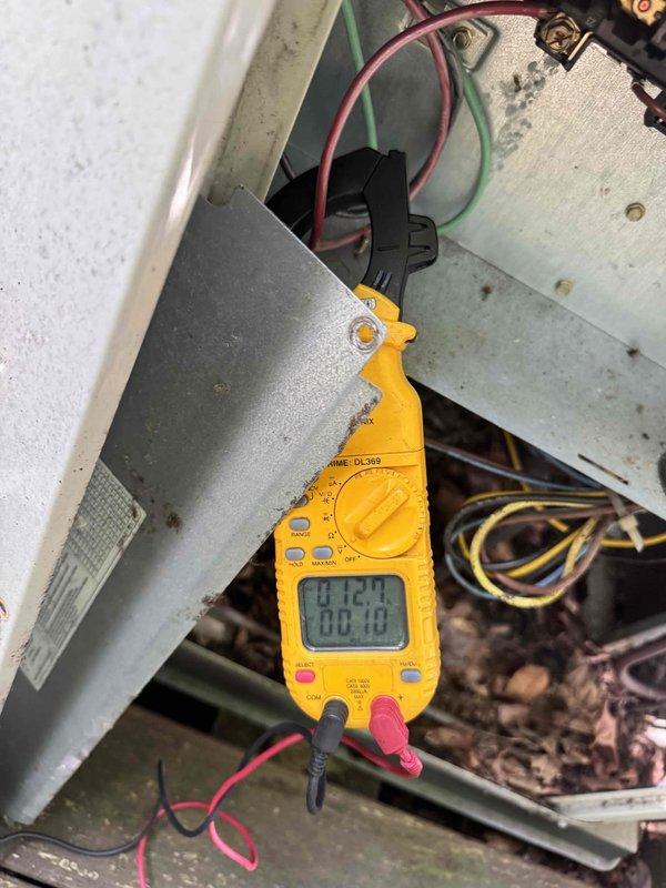 Responded to no cooling complaint on aging residential air conditioning system. Upon arrival, performed diagnostic evaluation of outdoor condensing unit and associated electrical components. Utilized digital multimeter to measure voltage and verify proper electrical supply to equipment, obtaining readings to assess system functionality. Inspected exterior disconnect boxes, conduit connections, and power supply infrastructure mounted on building exterior. Conducted thorough assessment of unit age and overall condition to determine serviceability and provide customer with repair versus replacement recommendations for their consideration.