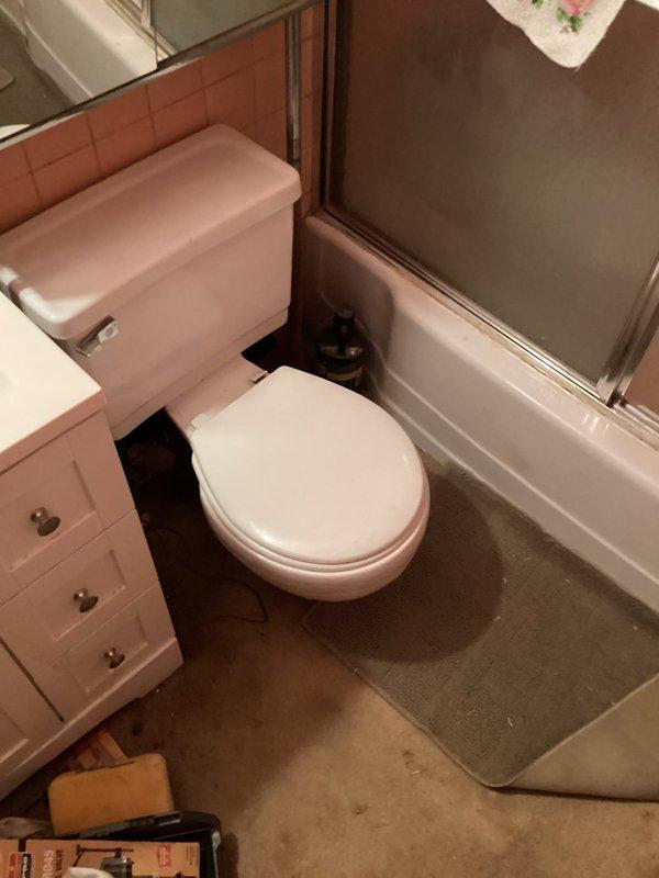 Responded to service call for multiple plumbing issues including non-functional water line behind washing machine, potential toilet replacement, and sink inspection. Upon arrival, assessed bathroom with existing toilet installation and examined utility area plumbing system. Inspected copper supply lines, shut-off valves, and water distribution system in basement mechanical room. Evaluated toilet condition and functionality, checked water supply connections, and examined bathroom sink plumbing. Documented existing conditions with photographs showing bathroom fixtures and basement utility piping configuration including flexible supply lines, mounting brackets, and valve assemblies.