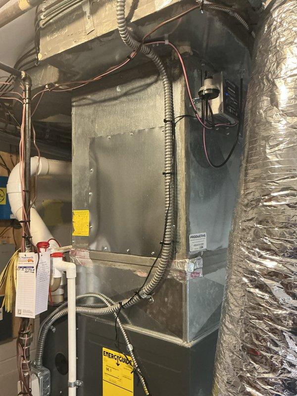Reconfigured dehumidifier ductwork system by extending both supply and return lines to optimize performance and prevent the unit from counteracting the primary HVAC system. Installed 20 feet of 10-inch flexible ductwork with proper support using zip ties and black cloth strapping, and patched existing access holes with metal panels to restore system integrity.