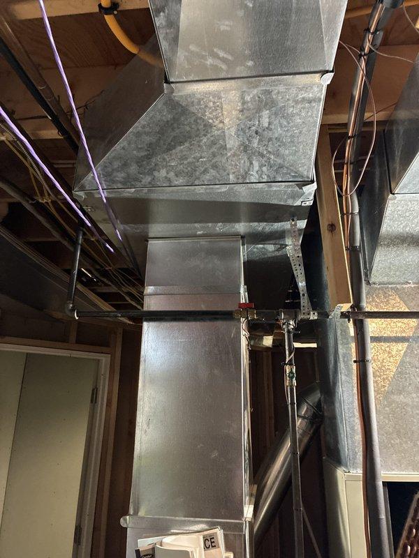 Performed comprehensive system evaluation and presented full HVAC replacement options to customer. Assessed existing ductwork configuration in mechanical space, noting aged galvanized metal components with visible wear and accumulated dust buildup. Documented current system layout including vertical and horizontal duct runs, reviewed equipment placement constraints, and created site diagram showing property configuration for optimal equipment positioning during future installation.