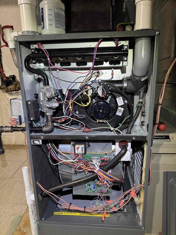 Completed comprehensive cooling system maintenance on residential HVAC unit. Performed interior inspection of furnace assembly, verifying blower motor operation, gas valve connections, and electrical wiring integrity throughout upper and lower compartments. Conducted electrical diagnostics on outdoor condensing unit using clamp meter, measuring amperage draw and voltage readings to confirm proper system performance and component function.
