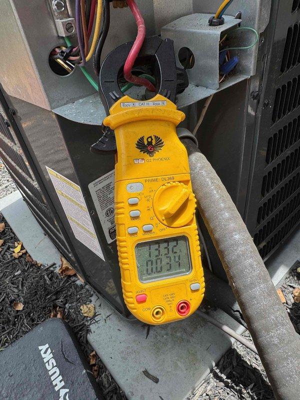 Completed comprehensive cooling system maintenance on residential HVAC unit. Performed interior inspection of furnace assembly, verifying blower motor operation, gas valve connections, and electrical wiring integrity throughout upper and lower compartments. Conducted electrical diagnostics on outdoor condensing unit using clamp meter, measuring amperage draw and voltage readings to confirm proper system performance and component function.