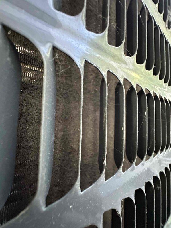 Performed routine HVAC cooling system maintenance on residential unit. Conducted electrical diagnostics using clamp meter to verify proper amperage and voltage levels at equipment. Inspected condenser coil and documented heavy accumulation of dirt and debris on fins, which restricts airflow and reduces system efficiency. Evaluated air filter condition for potential replacement to maintain optimal system performance and indoor air quality.
