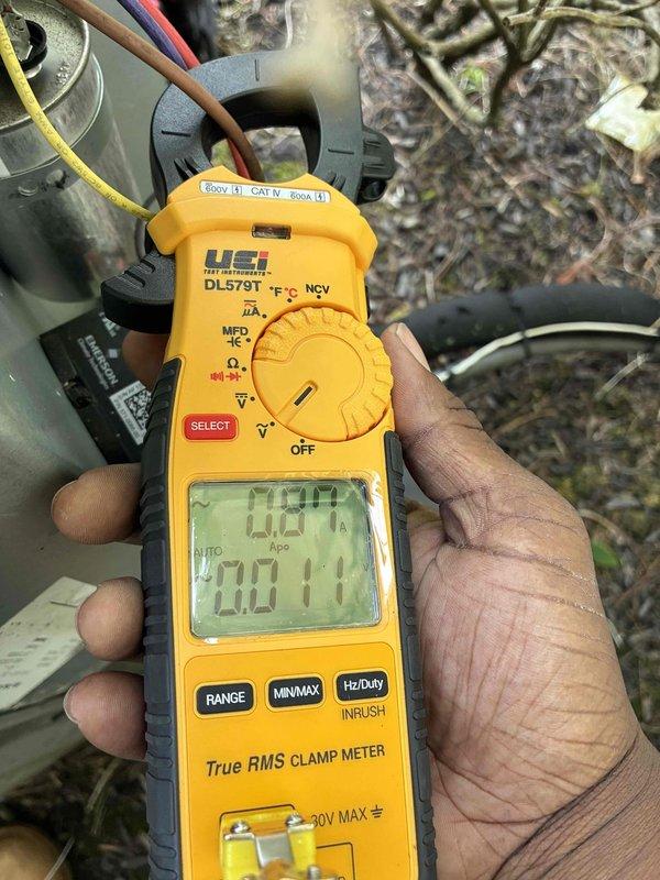 Completed scheduled preventive maintenance on residential cooling system. Performed electrical diagnostics using clamp meter to verify proper amperage draw and voltage readings at outdoor condensing unit, confirming system operating within manufacturer specifications at 70.11 volts with zero amp draw at time of measurement. Inspected electrical control panel and wiring connections, noting all conductors properly secured and terminals tight with no signs of overheating or electrical faults.