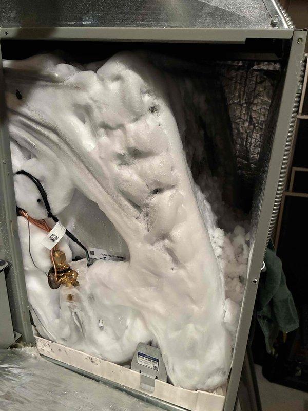 Responded to no-cool call on recently installed 2-day-old system with indoor temperature in the 80s. Upon inspection, discovered extensive frost and ice buildup throughout the evaporator coil compartment, indicating improper refrigerant charge or airflow restriction from installation. Found wiring issues from initial installation that caused intermittent fan operation. Corrected improper electrical connections that installers had attempted to troubleshoot. Addressed incomplete installation work including unfinished thermostat installation. Verified proper system operation, airflow, and refrigerant charge after corrections were made to restore cooling capacity.