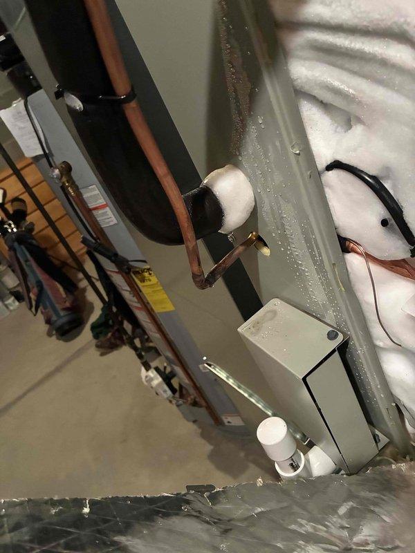 Responded to no-cool call on recently installed 2-day-old system with indoor temperature in the 80s. Upon inspection, discovered extensive frost and ice buildup throughout the evaporator coil compartment, indicating improper refrigerant charge or airflow restriction from installation. Found wiring issues from initial installation that caused intermittent fan operation. Corrected improper electrical connections that installers had attempted to troubleshoot. Addressed incomplete installation work including unfinished thermostat installation. Verified proper system operation, airflow, and refrigerant charge after corrections were made to restore cooling capacity.