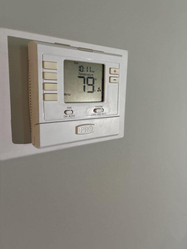 Completed comprehensive evaluation of existing HVAC system and provided full system replacement options to customer. Documented current equipment configuration including outdoor condensing unit location near electrical service panel and utility meters on exterior wall, as well as interior thermostat (PRO model programmable unit currently reading 79°F). Presented multiple replacement system proposals with varying efficiency levels and features for customer consideration.