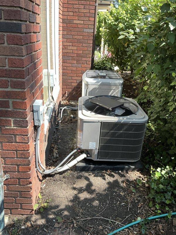 Conducted comprehensive HVAC system evaluation for replacement estimate on existing Unico system with reported refrigerant leak and high repair costs from previous assessment. Inspected dual outdoor condenser units, crawlspace ductwork including flexible metal ducts and PVC condensate lines, and evaluated overall system condition to provide replacement options for the customer.