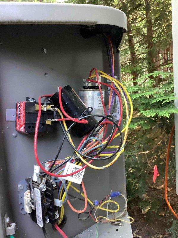 Completed scheduled preventive maintenance on residential cooling system. Inspected and photographed outdoor disconnect panel with electrical components including contactors, capacitor, and associated wiring connections. Verified indoor air handler unit and plumbing connections in utility area were operating within normal parameters.
