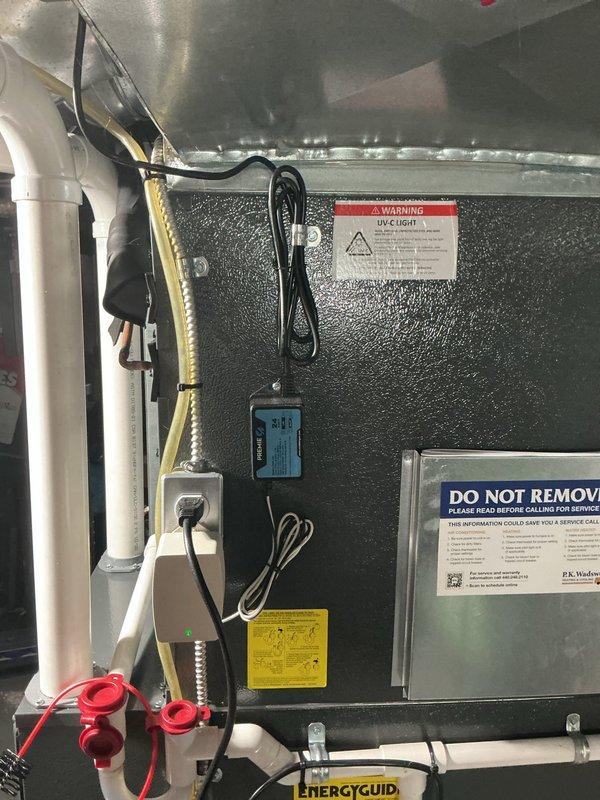 Completed comprehensive cooling system maintenance on residential HVAC unit. Inspected air handler, condensate drainage system with PremierOne condensate pump, ductwork connections, and all electrical components including control board and safety switches. System tested and operating within normal parameters; all warning labels and safety documentation verified in place.