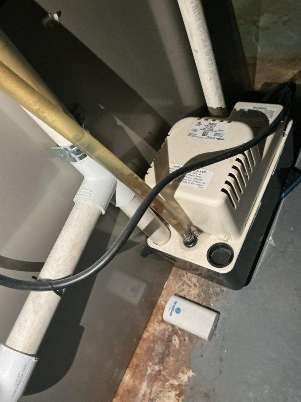 Completed routine cooling maintenance on residential HVAC system. Inspected indoor air handler components in attic space, including condensate pump assembly with drainage lines and PVC piping. Verified proper operation of condensate removal system and checked monitoring sensors. Proceeded to outdoor condenser unit where heavy accumulation of dirt, dust, and debris was observed on coil fins and protective grilles. Cleaned condenser coils to restore optimal airflow and heat transfer efficiency. Inspected unit mounting, electrical connections, and overall system operation. All components functioning within normal parameters following maintenance completion.