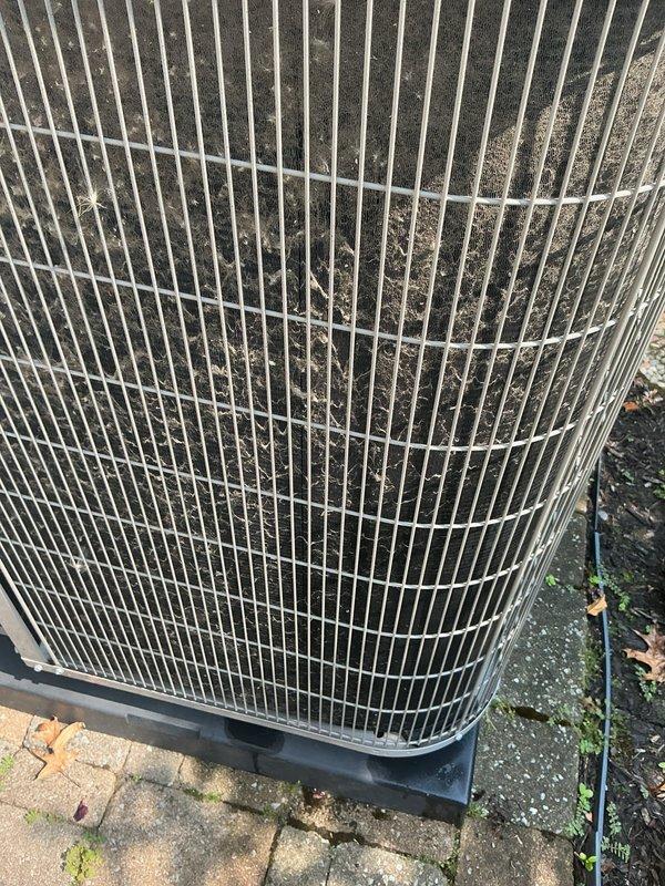 Completed routine cooling maintenance on residential HVAC system. Inspected indoor air handler components in attic space, including condensate pump assembly with drainage lines and PVC piping. Verified proper operation of condensate removal system and checked monitoring sensors. Proceeded to outdoor condenser unit where heavy accumulation of dirt, dust, and debris was observed on coil fins and protective grilles. Cleaned condenser coils to restore optimal airflow and heat transfer efficiency. Inspected unit mounting, electrical connections, and overall system operation. All components functioning within normal parameters following maintenance completion.