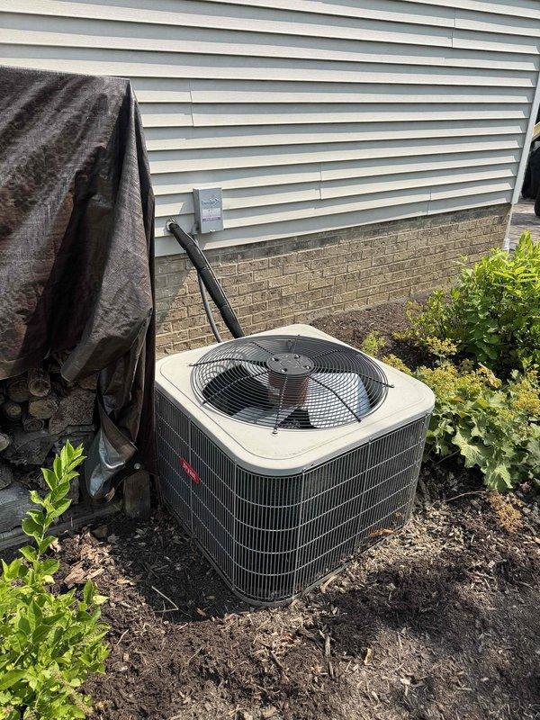 Performed routine cooling maintenance on residential outdoor condensing unit. Inspected and tested electrical components including fuse block assembly, verified proper amperage and connections, and confirmed system operation. Cleared debris from surrounding area and ensured adequate airflow around unit for optimal performance.