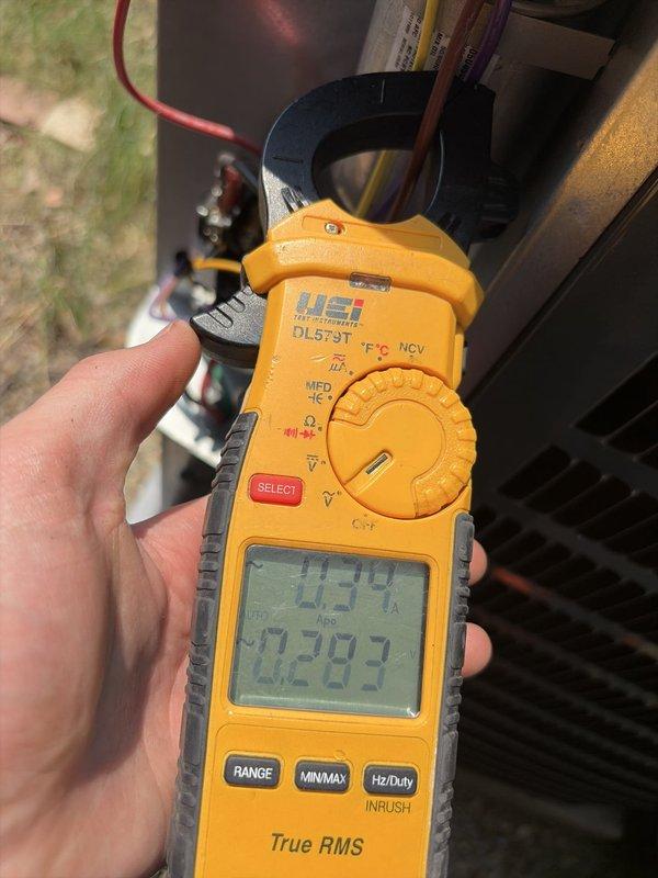 Completed preventive maintenance on residential cooling system with Amana furnace and air conditioning unit. Performed electrical diagnostics using clamp meter, recording amperage draw of 0.39A and voltage reading of 282.7V to verify proper system operation. Inspected condensate drain line, ductwork connections, and overall equipment condition. All components found operating within normal parameters with no issues identified.