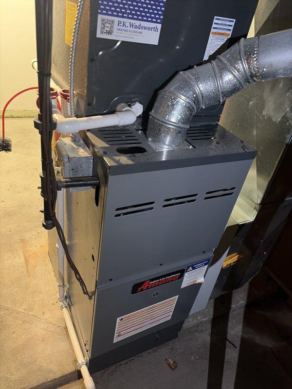 Completed preventive maintenance on residential cooling system with Amana furnace and air conditioning unit. Performed electrical diagnostics using clamp meter, recording amperage draw of 0.39A and voltage reading of 282.7V to verify proper system operation. Inspected condensate drain line, ductwork connections, and overall equipment condition. All components found operating within normal parameters with no issues identified.