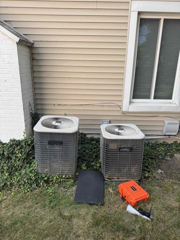 Responded to service call for clogged and leaking air conditioning system. Upon inspection, identified blockage in condensate drain line causing water backup and leakage. Cleared obstruction from drain line, replaced damaged pipe coupling, and verified proper drainage flow. Inspected both outdoor condenser units for proper operation and confirmed system returned to normal functioning without further leaks.