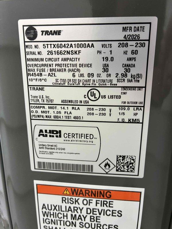 Completed system start-up and commissioning on newly installed Trane 5TTX6042A1000AA condensing unit. Verified electrical specifications including 208-230V single-phase power supply, confirmed proper amperage draw at 0.99A during operation, and validated all safety labels and manufacturer documentation are properly affixed to equipment. All systems tested and operating within normal parameters.