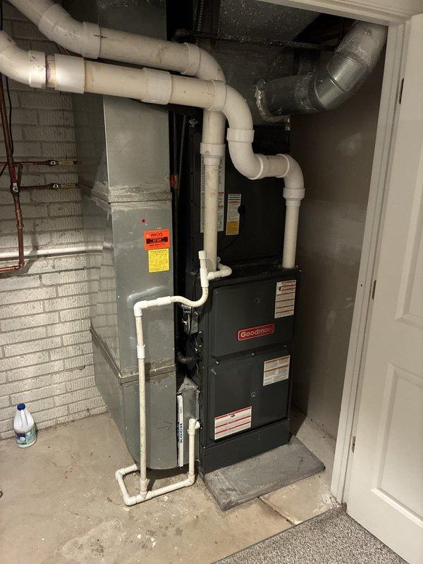 Completed full air conditioning system installation including new Goodman outdoor condenser unit positioned on concrete pad and indoor evaporator coil paired with existing furnace. Installed refrigerant lines with proper insulation, established all necessary electrical connections, and configured condensate drainage system with PVC piping. System was charged with refrigerant, tested for proper operation, and verified to be cooling effectively, resolving the no-cooling condition.