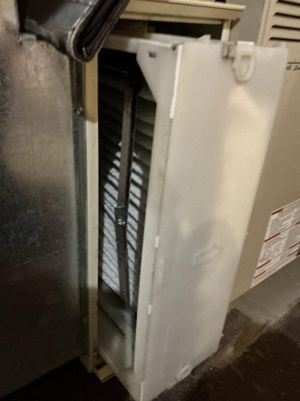 Conducted comprehensive evaluation of existing HVAC system for replacement estimate. Assessed older but operational furnace and air conditioning equipment located in basement utility area. Documented current system condition, including two-tier metal air handler unit with visible age-related wear on lower components, and furnace unit with accessible filter assembly. Photographed equipment configuration, ductwork connections, and installation layout to provide detailed replacement options and recommendations for system upgrade.