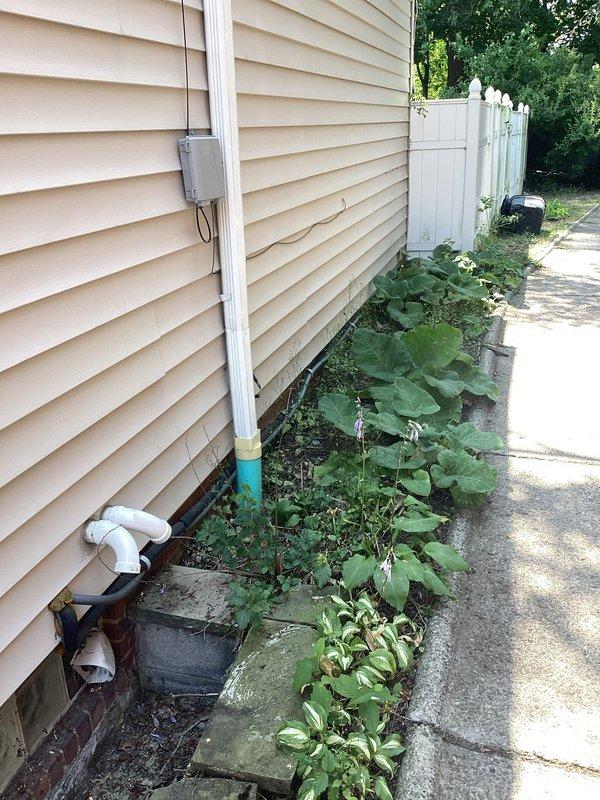 Completed residential generator installation estimate for property received through Generac lead program. Evaluated existing electrical service entrance, including weatherhead mast, meter location, and service cable routing on exterior wall with vinyl siding. Assessed available installation space along side yard adjacent to concrete walkway and privacy fence, noting vegetation clearance requirements and drainage considerations near foundation. Documented current electrical infrastructure configuration to determine transfer switch placement, generator pad location, and necessary electrical connections for whole-house backup power system.