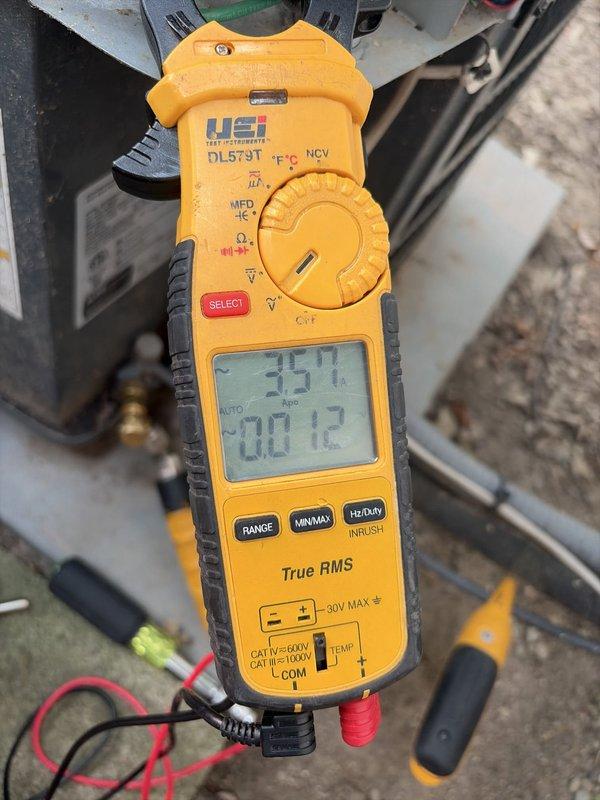 Completed comprehensive cooling system tune-up and inspection. Performed electrical diagnostics using digital multimeter to verify system voltage and capacitance readings, confirming proper electrical operation of HVAC unit. Documented exterior electrical service connection and meter installation as part of routine system assessment.