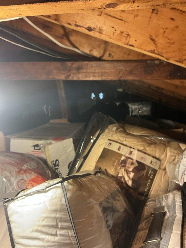 Responded to air conditioning leak complaint. Upon inspection, found evidence of water damage on interior ceiling with visible staining in living area. Accessed attic space and located source of condensate leak from AC system. Inspected drain line routing and evaporator coil area. Cleared clogged condensate drain line and verified proper drainage flow. Tested system operation to confirm leak was resolved and no further water intrusion occurring.